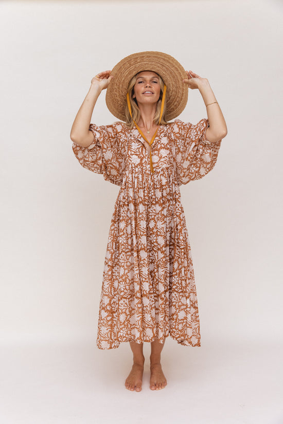 Daughters of India Kyra Midi Dress in Caramel — studio full length with straw hat, V-neckline, hand screen print cotton