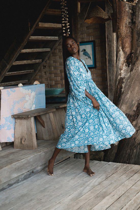 Daughters of India Kyra Midi Dress in Ocean Blue — twirling on wooden deck of treehouse, flowing hand screen print