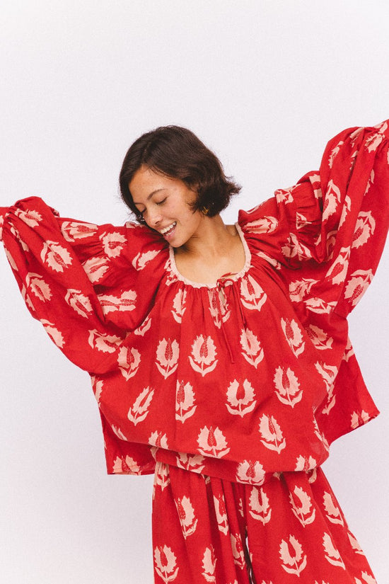 Ria Blouse Ruby Red — waist tie detail close-up, ruby red hand block print cotton blouse showing gathered waist with tie closure and botanical leaf motif, artisan Jaipur India | Daughters of India