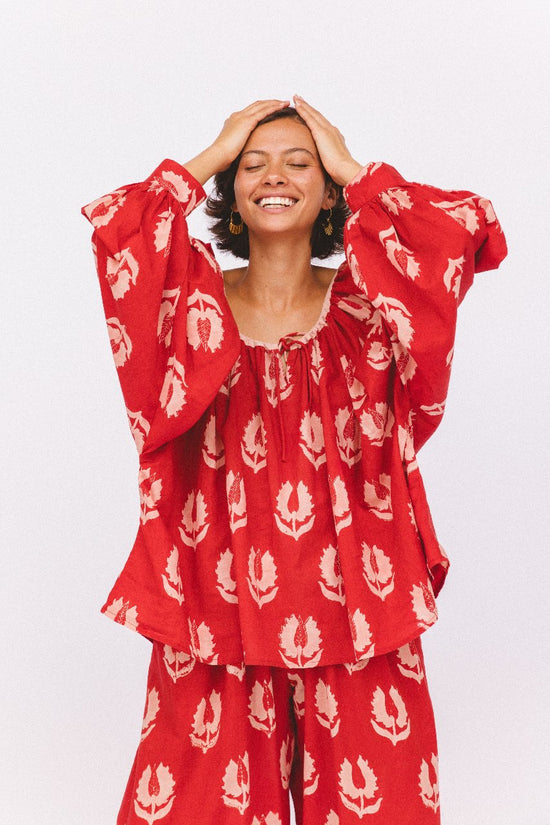 Ria Blouse Ruby Red — studio mid-body front view, model wearing coordinating ruby red hand block print cotton blouse and wide-leg pants set, botanical leaf motif, relaxed fit, artisan Jaipur India | Daughters of India