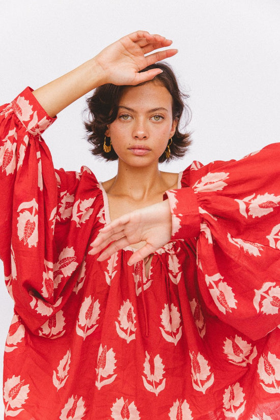 Ria Blouse Ruby Red — fabric detail close-up, ruby red hand block print cotton with white botanical leaf motif pattern, Sanganer Jaipur artisan textile craft | Daughters of India